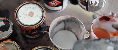 a group of cans of paint sitting next to each other