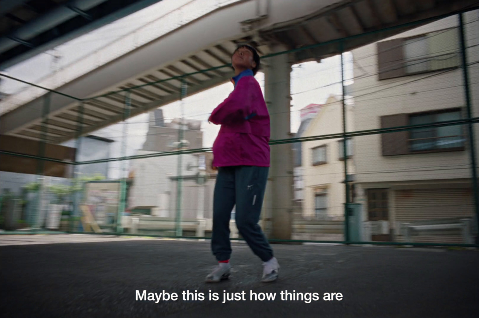 a man in a pink jacket is skateboarding