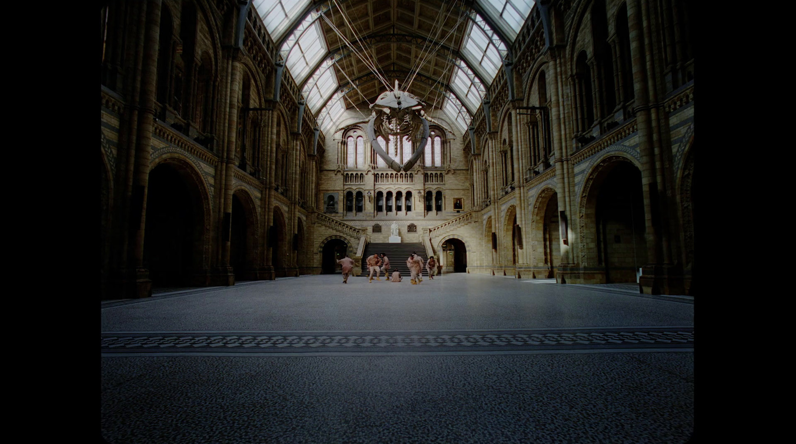 a group of people standing inside of a large building