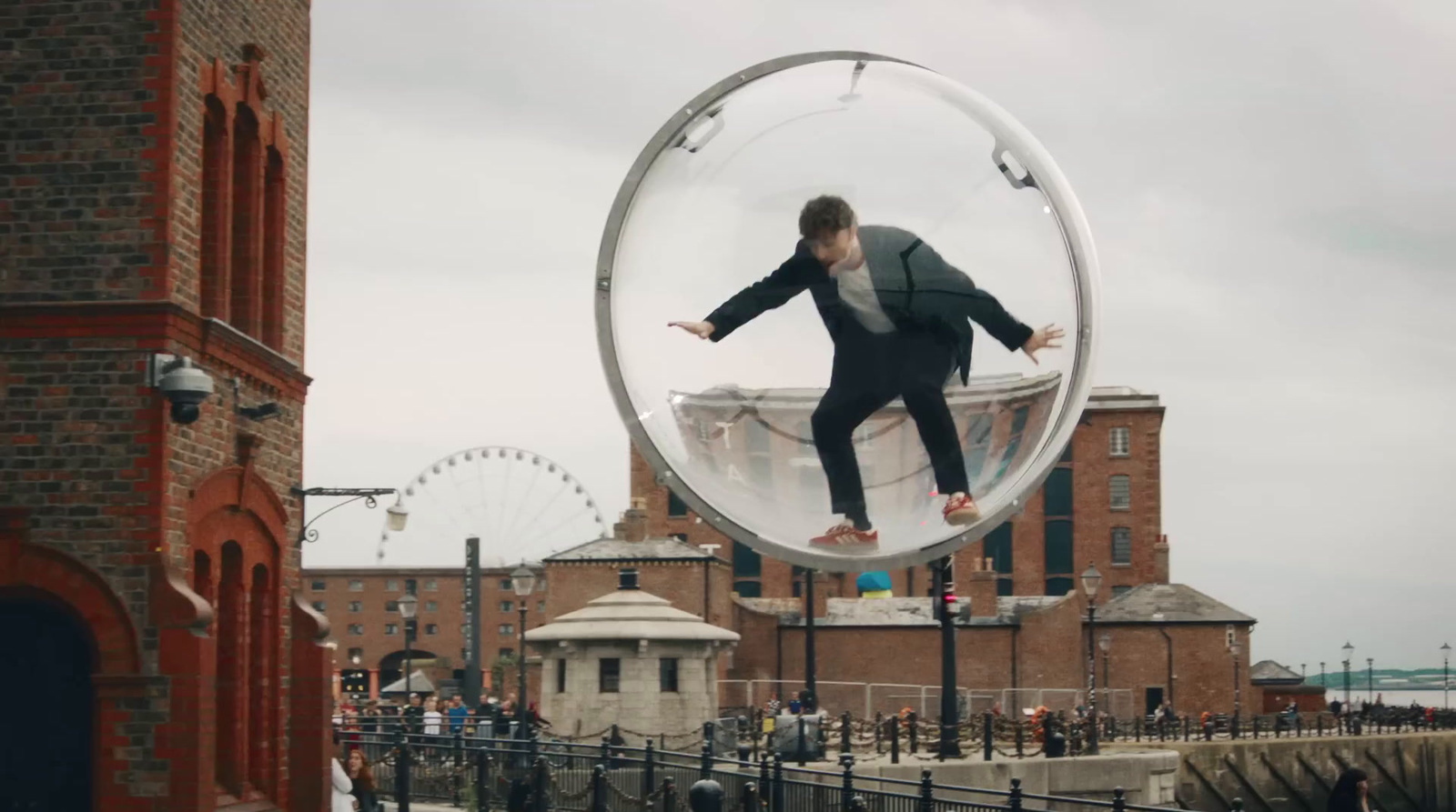 a man in a suit jumping through a circular object