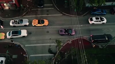 a group of cars that are sitting in the street