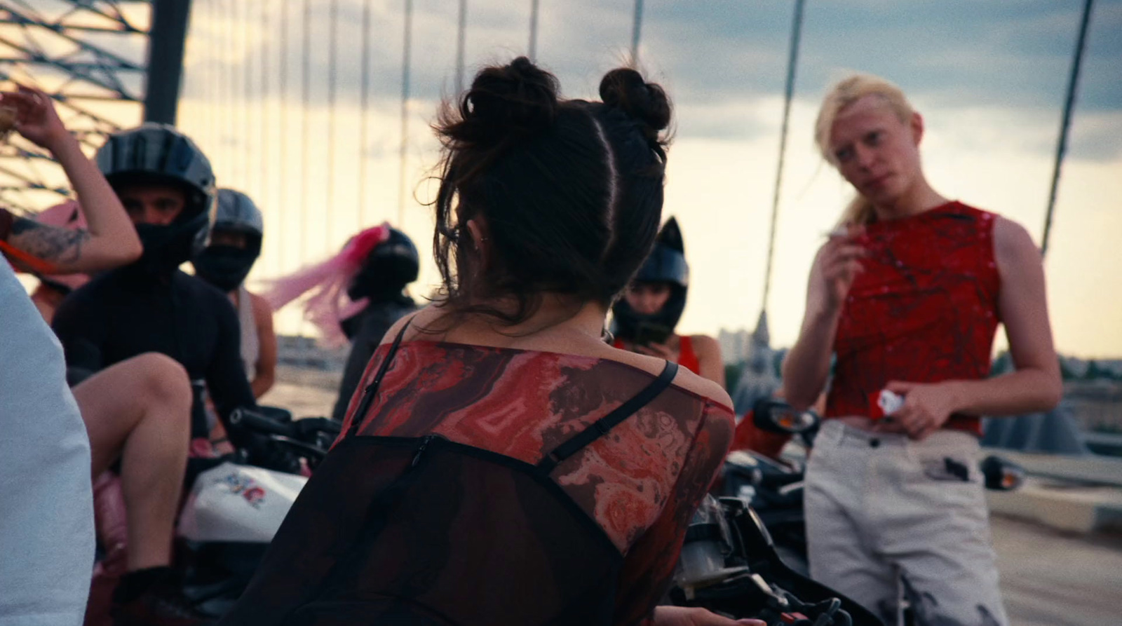 a group of people riding motorcycles on a bridge