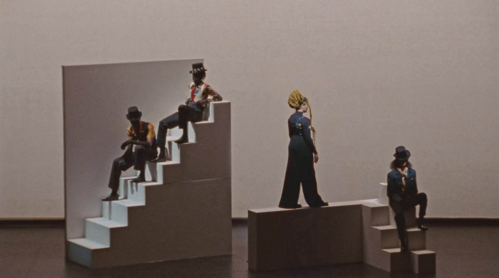 a group of figurines sitting on top of a set of stairs