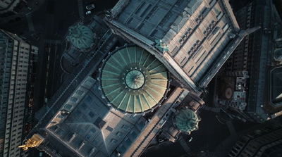 an aerial view of a building with a green dome