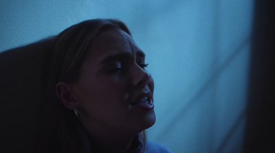 a woman with her mouth open in a dark room