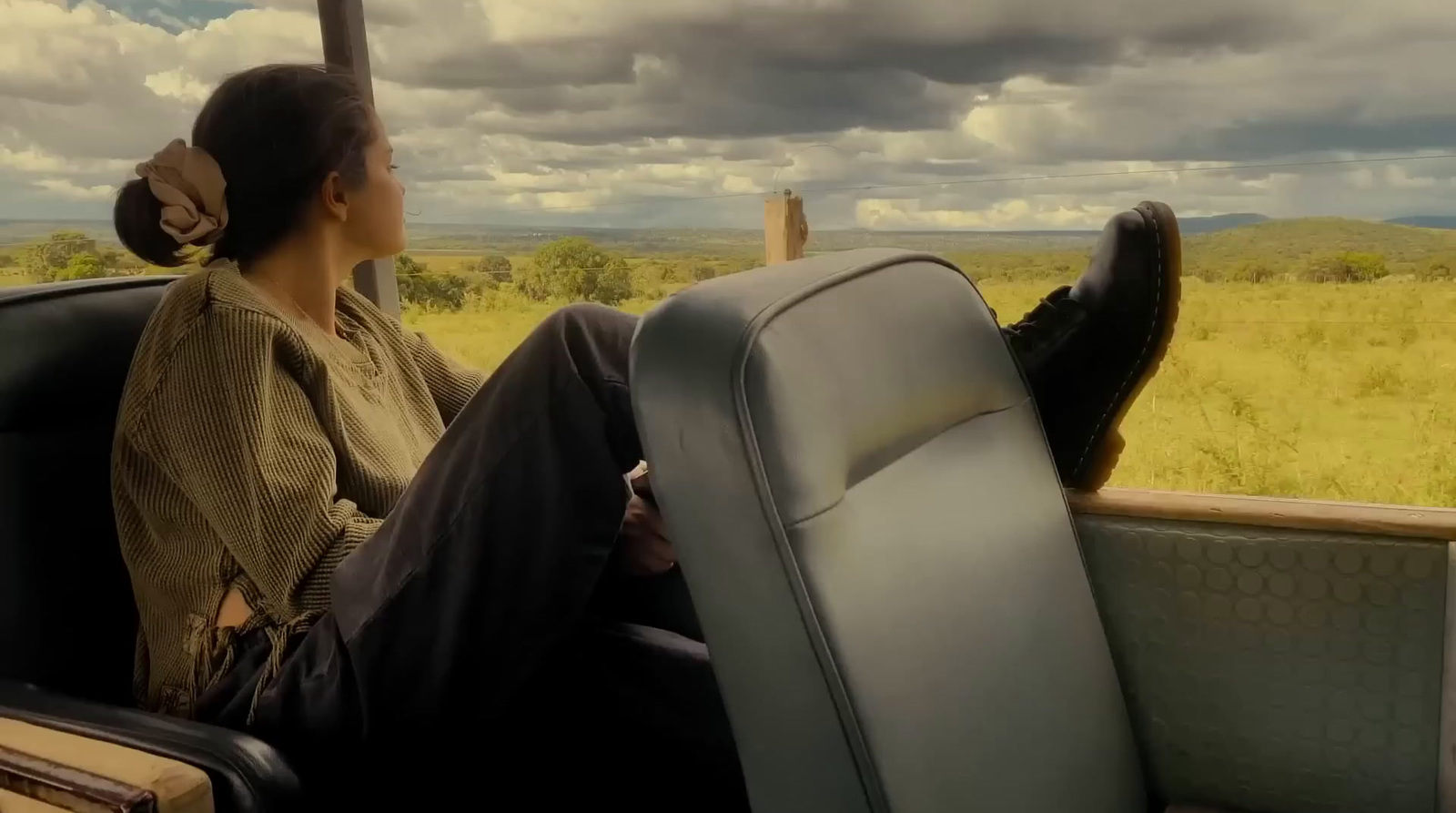 a woman sitting on a train looking out the window