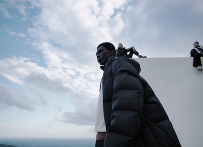 a man standing on top of a building next to another man