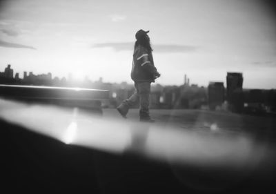 a black and white photo of a person walking