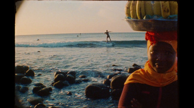 a person standing on a surfboard in the ocean