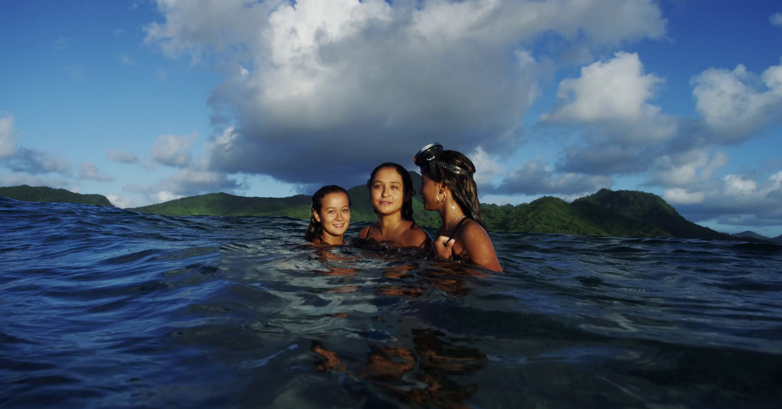 a group of women swimming in the ocean