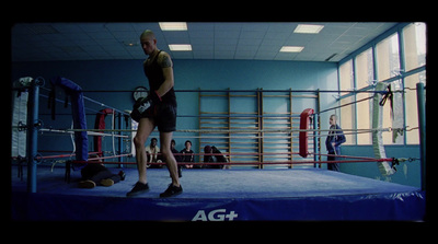 a man standing on top of a boxing ring