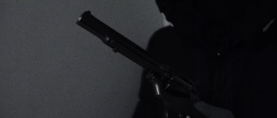 a person holding a gun in a dark room