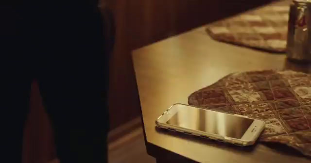 a cell phone sitting on top of a wooden table