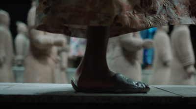 a close up of a person's shoes in front of mannequins