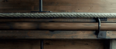 a close up of a wooden wall with a rope on it