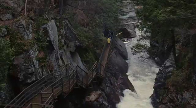 a man standing on a bridge over a river