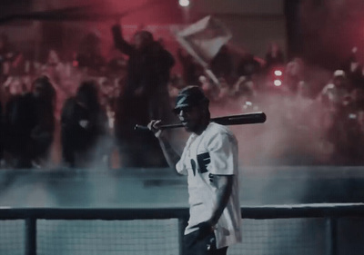 a man holding a baseball bat in front of a crowd