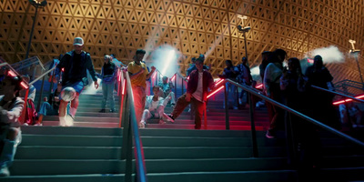 a group of people standing on top of a set of stairs