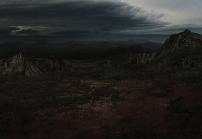 a dark landscape with a mountain in the background