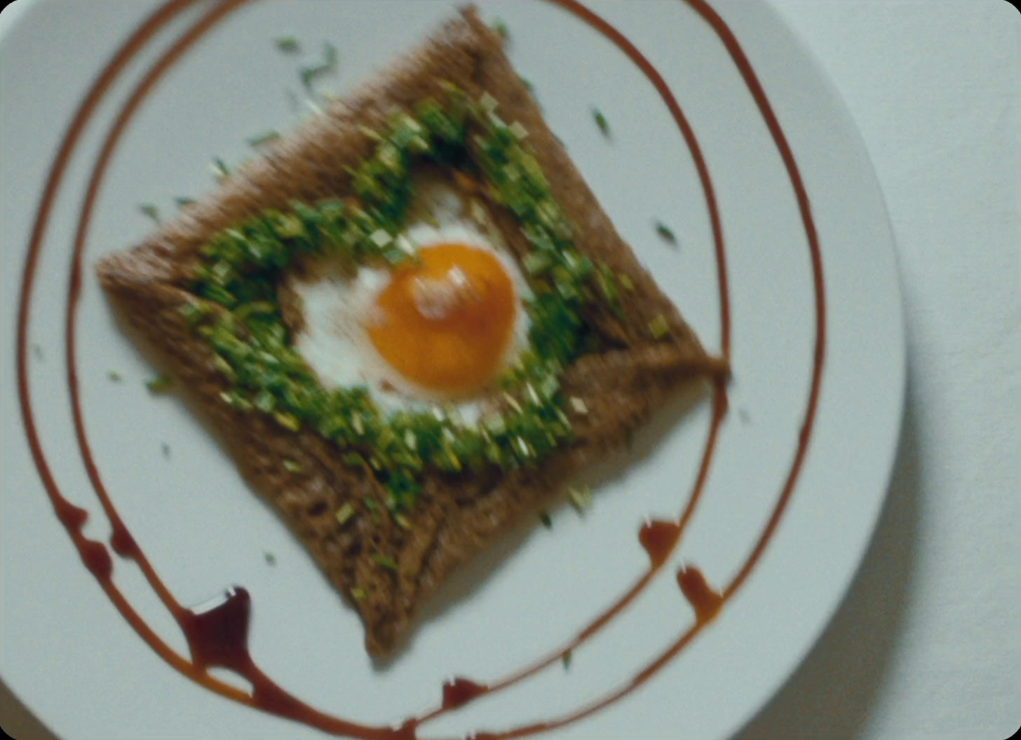 a white plate topped with a piece of food