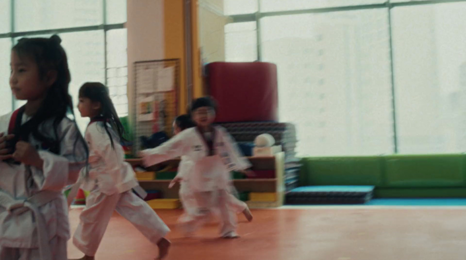 a group of young children in karate uniforms