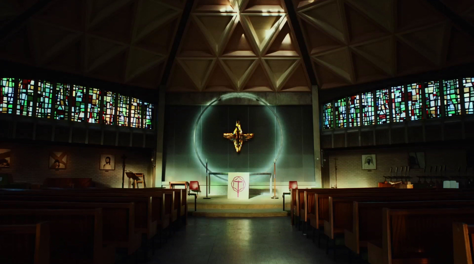 a dimly lit church with stained glass windows