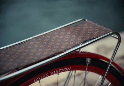 a close up of a red bicycle with a brown case