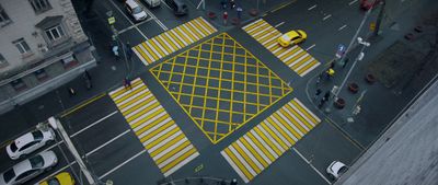 an overhead view of a parking lot with yellow and white markings