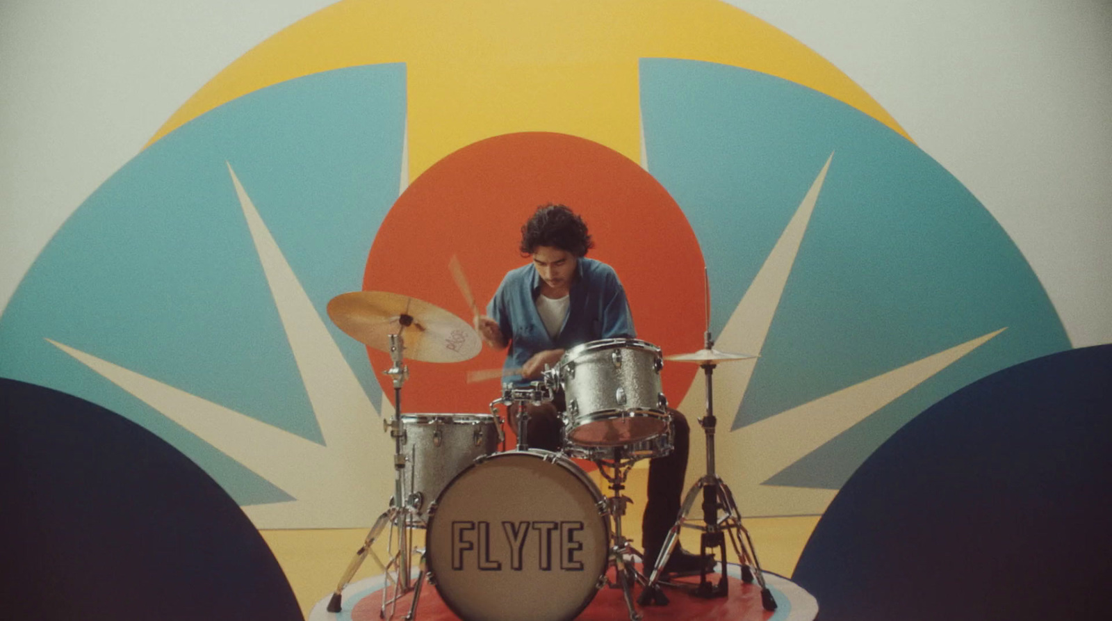 a man is playing drums on a stage