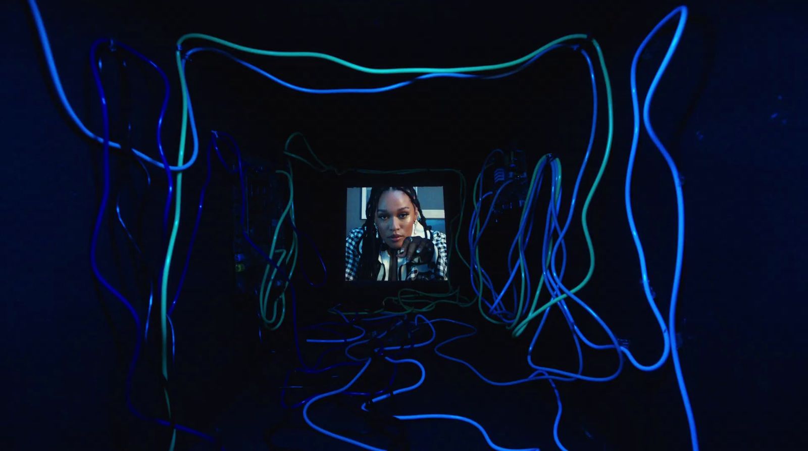 a woman is seen through a tunnel of neon lights