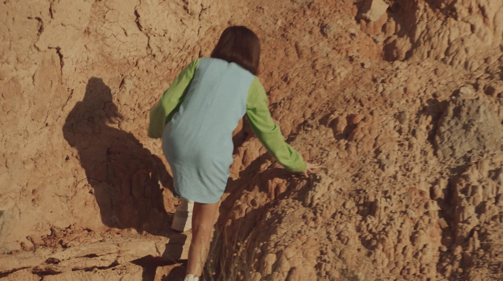 a person climbing up the side of a mountain