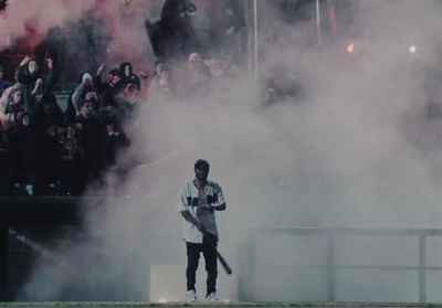 a man holding a baseball bat in front of a crowd of people