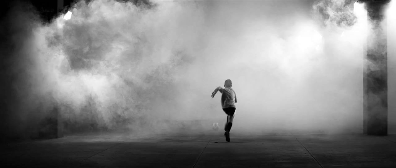 a man standing in front of a wall of smoke