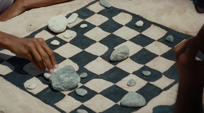 a close up of a person playing a game of chess