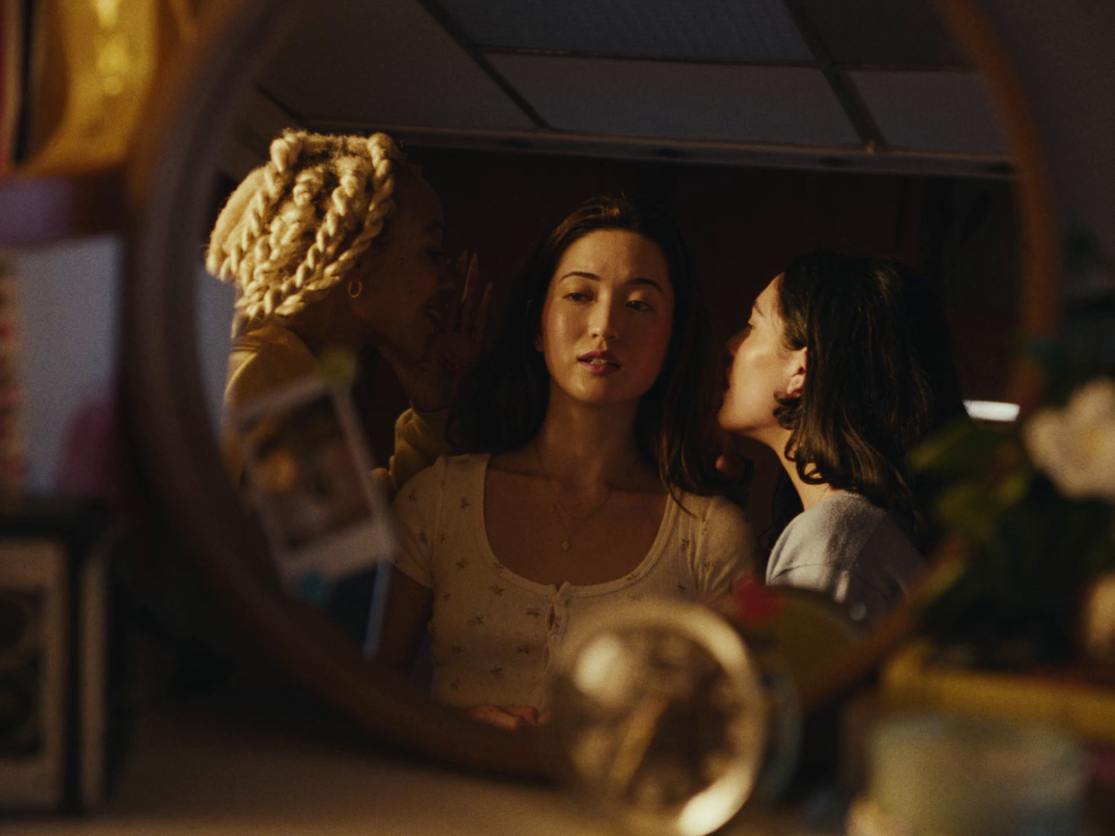 a group of women standing in front of a mirror