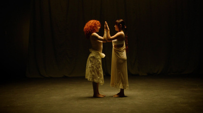 a couple of women standing next to each other on a stage