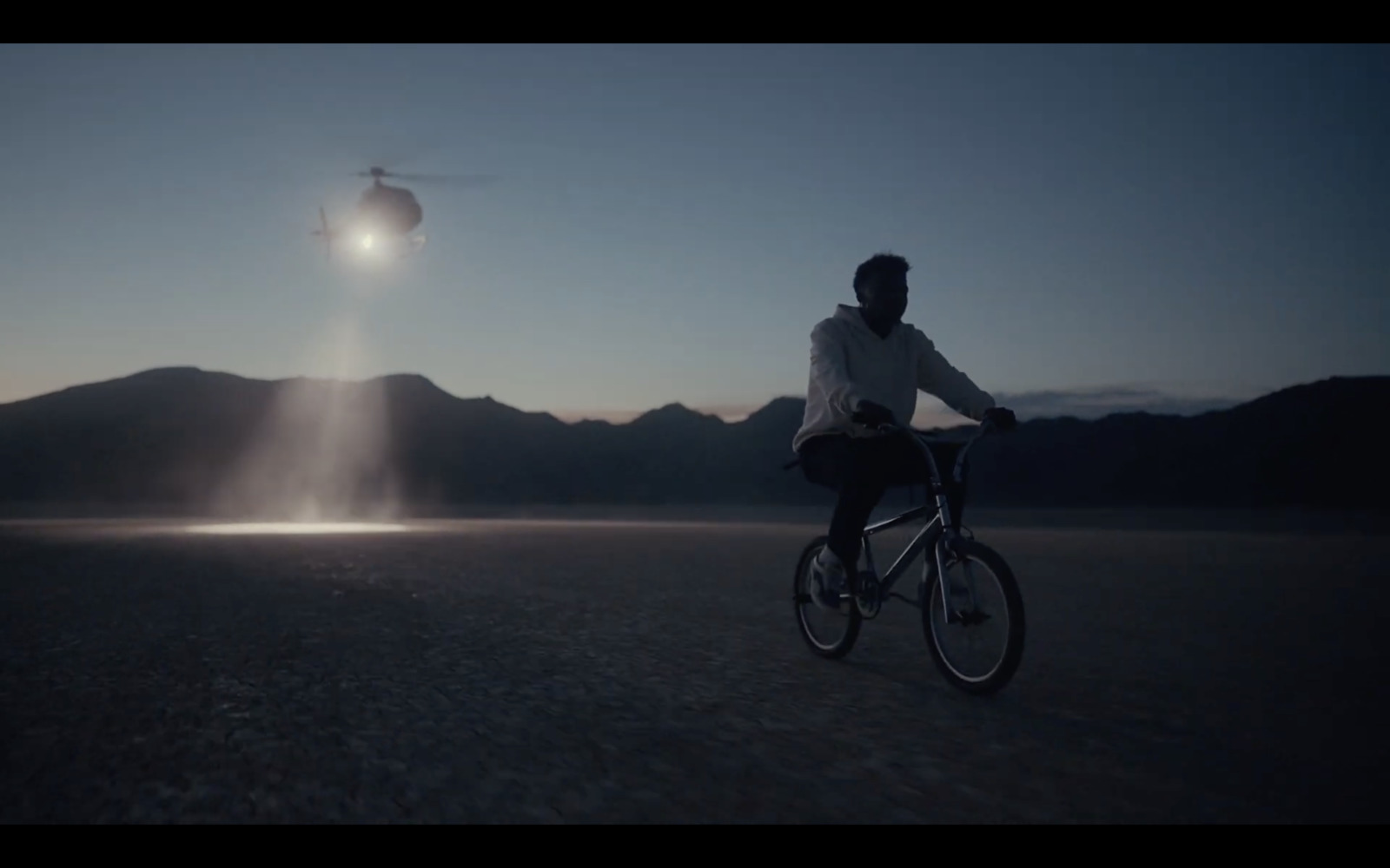 a man riding a bike in the middle of a desert