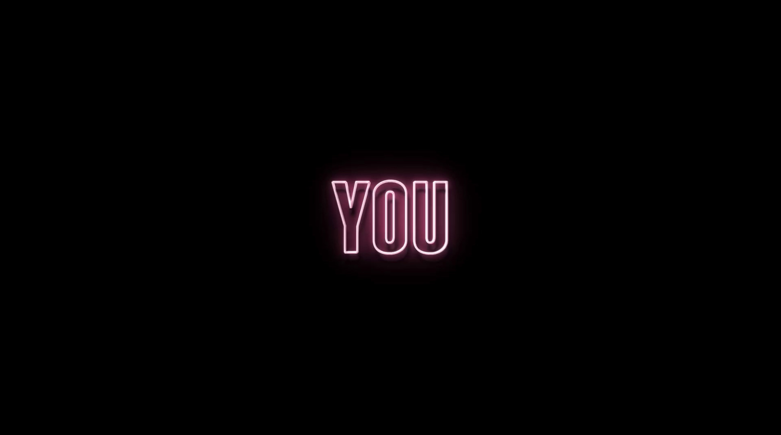 a neon sign that says you in a dark room