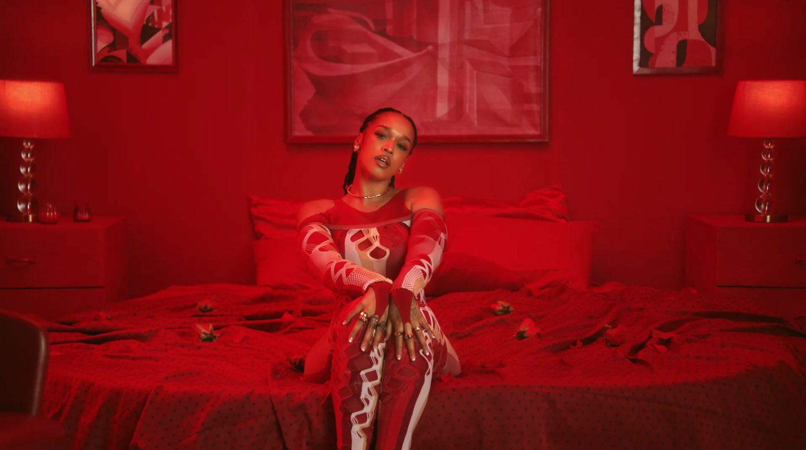 a woman sitting on a bed in a red room