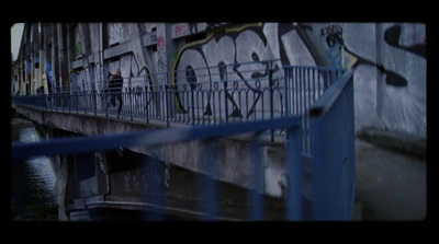 a graffiti covered wall next to a metal fence