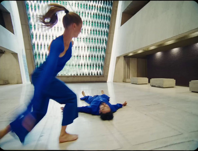 a woman in a blue jumpsuit and a girl in a blue jumpsuit are