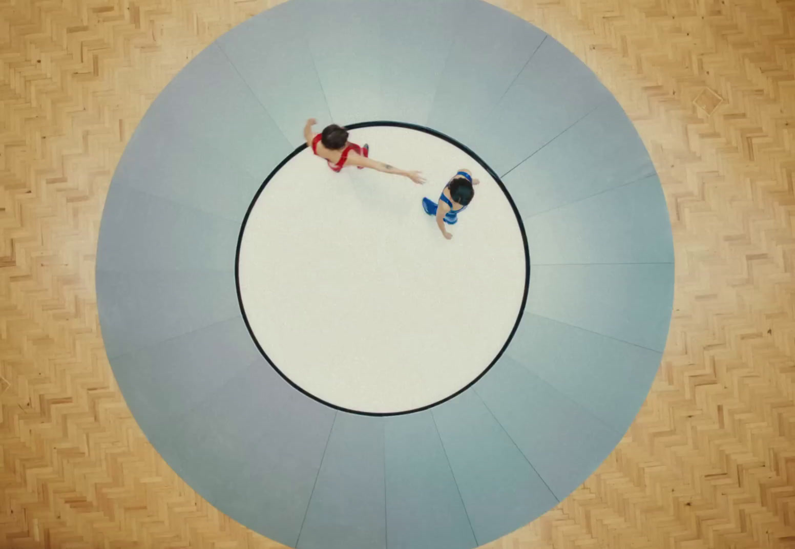 a couple of people standing on top of a circular object