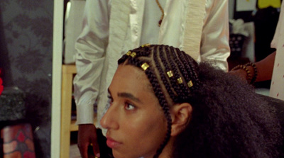 a woman with braids in a hair salon