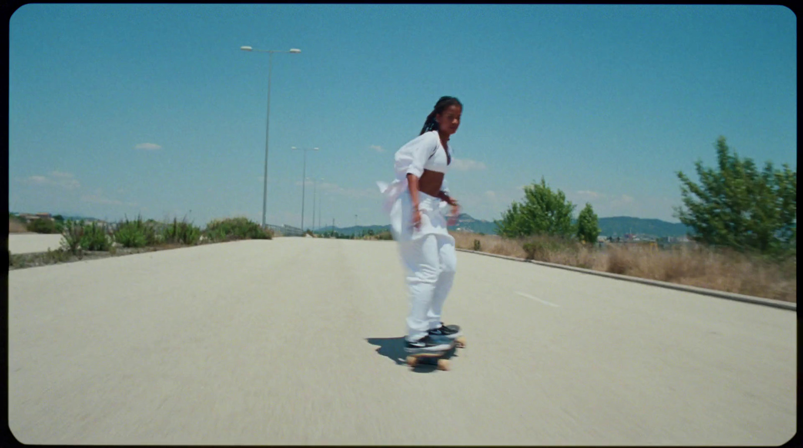 a man riding a skateboard down a street