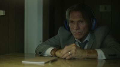 a man wearing headphones sitting at a table