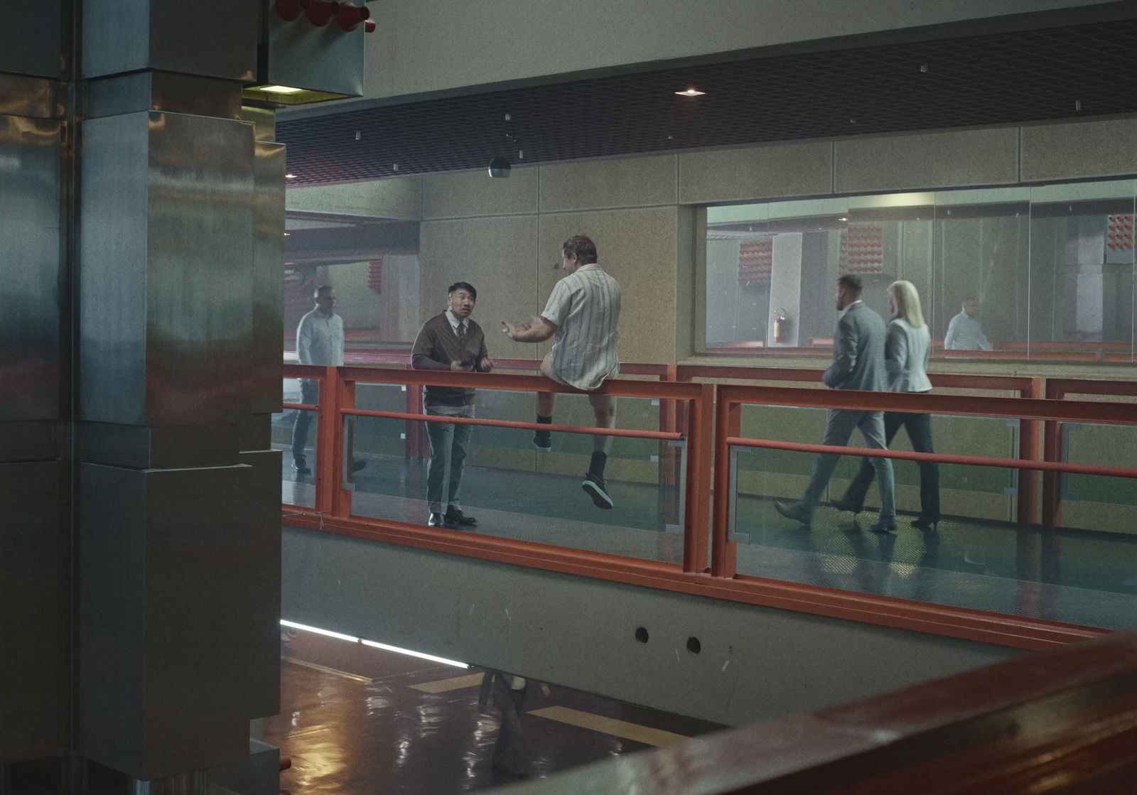 a group of people walking across a bridge