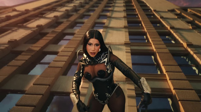 a woman in a futuristic suit standing in front of a tall building