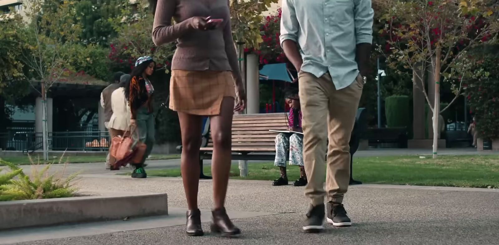 a man and a woman walking down a sidewalk