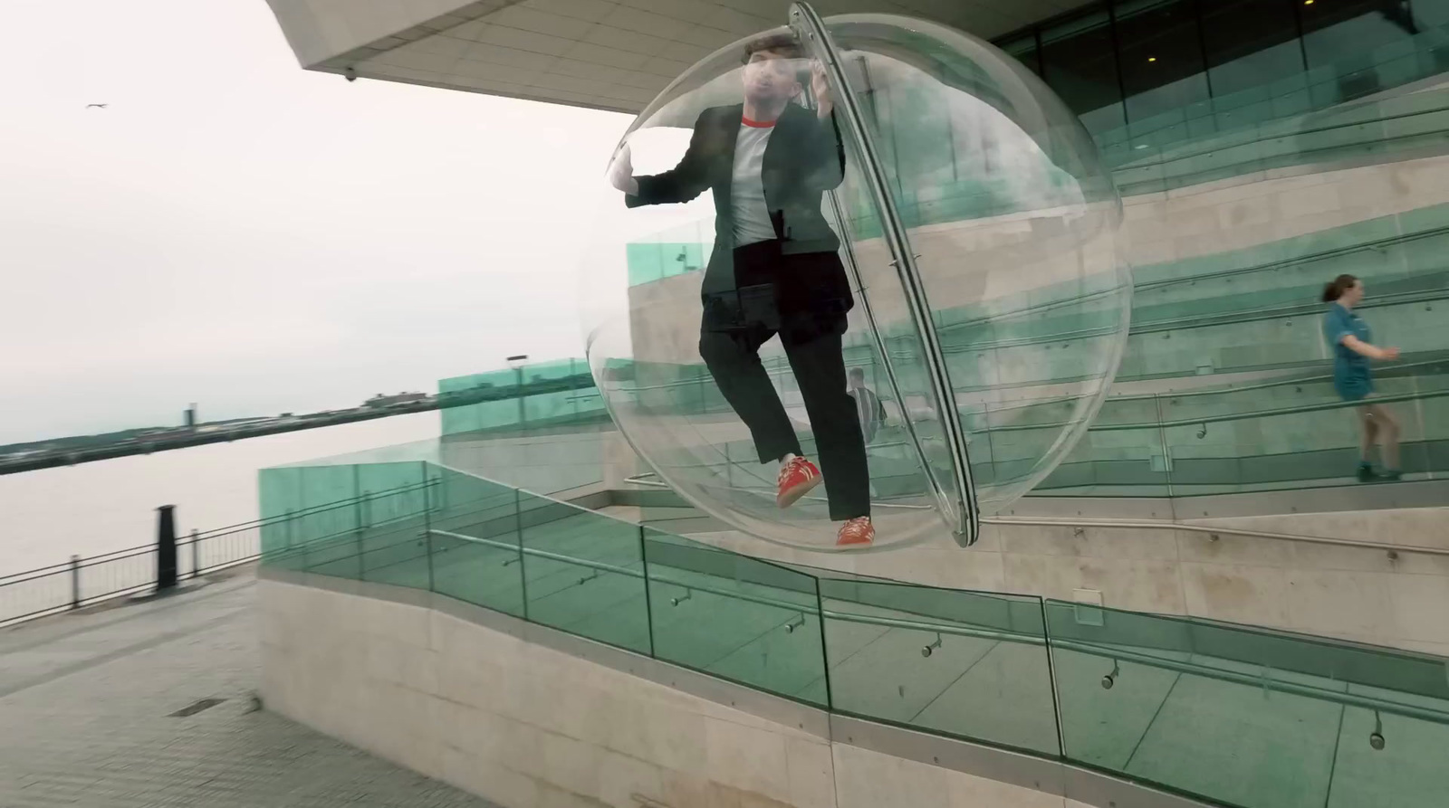 a man standing inside of a large glass ball