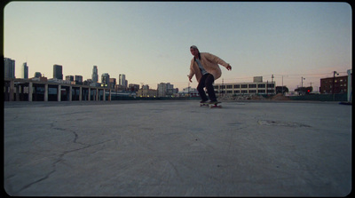 a man riding a skateboard down a cement road